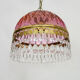 Vintage rose pendant light with pendants and patterned glass globe.