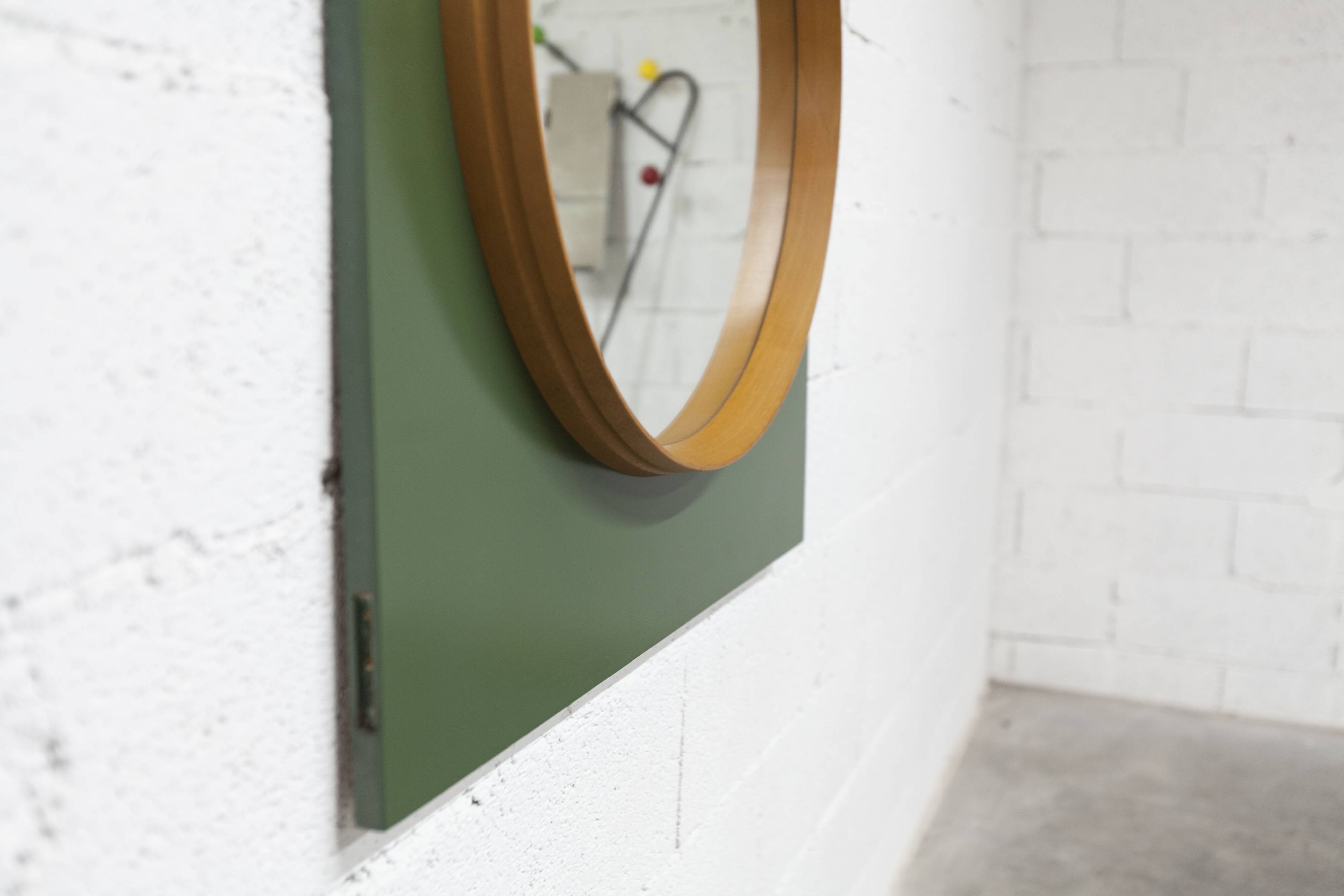 Unusual round wall mirror 60 cm teak edge on green rectangular board 1960.