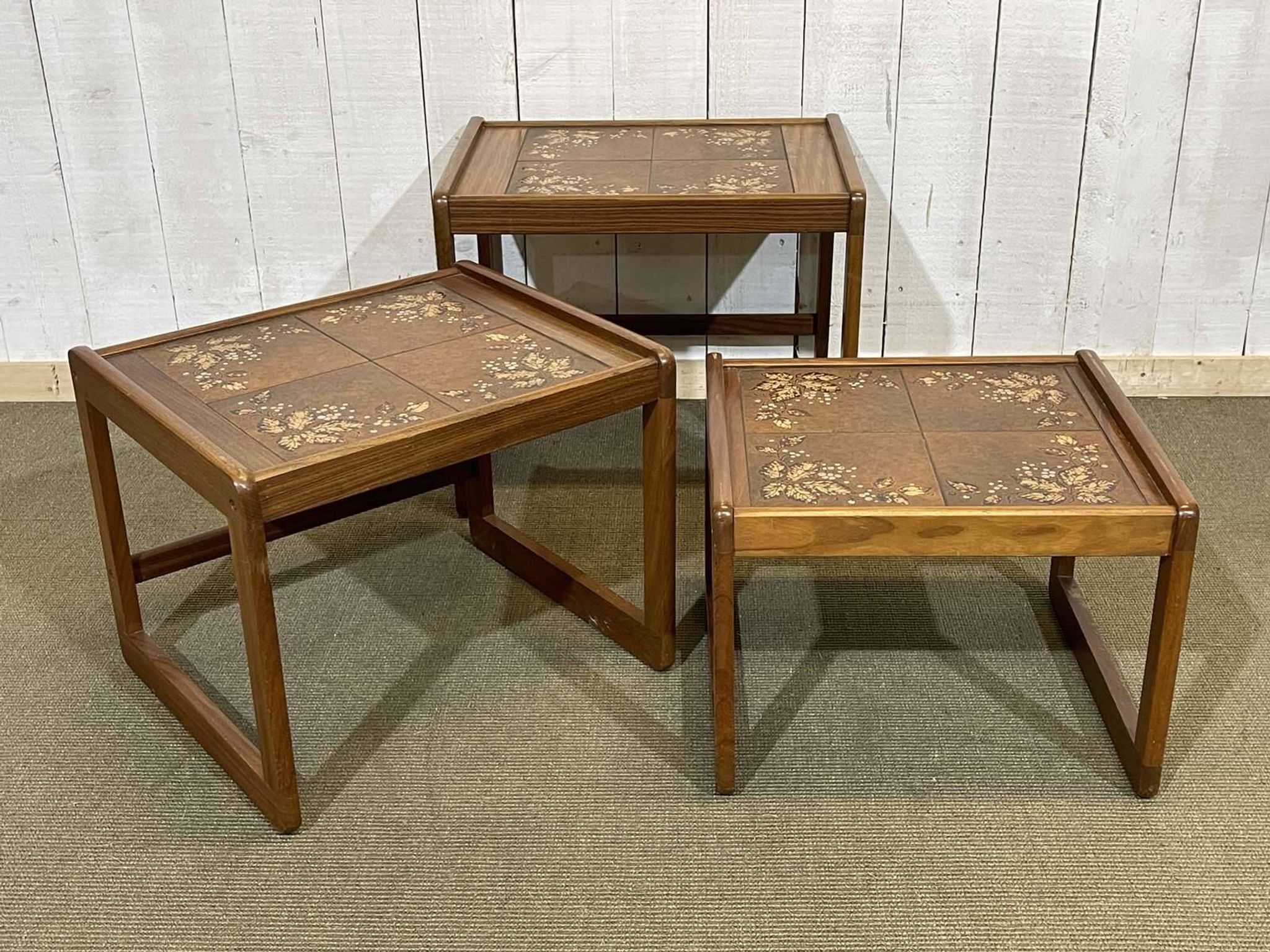 Set of 3 nesting tables in teak with tiled tops.