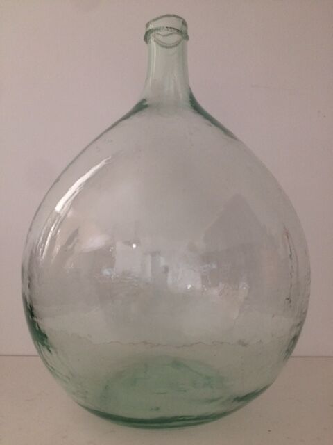 Transparent old demijohn about 8 to 10 L