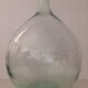 Transparent old demijohn about 8 to 10 L