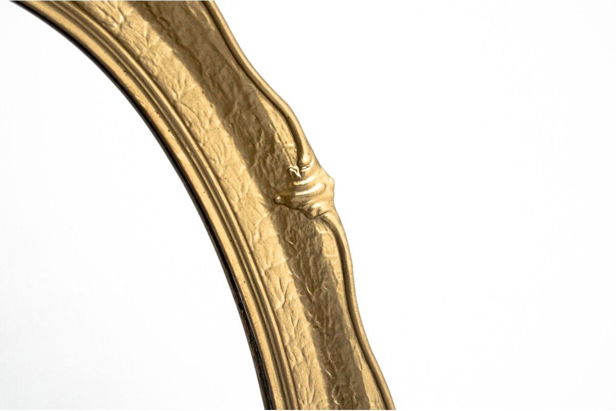 Oval mirror in a golden frame