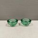 Un ensemble de porte-bougies iittala en verre transparent vert.
