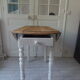 Oval table with beaded grey patinated flaps, wooden tray