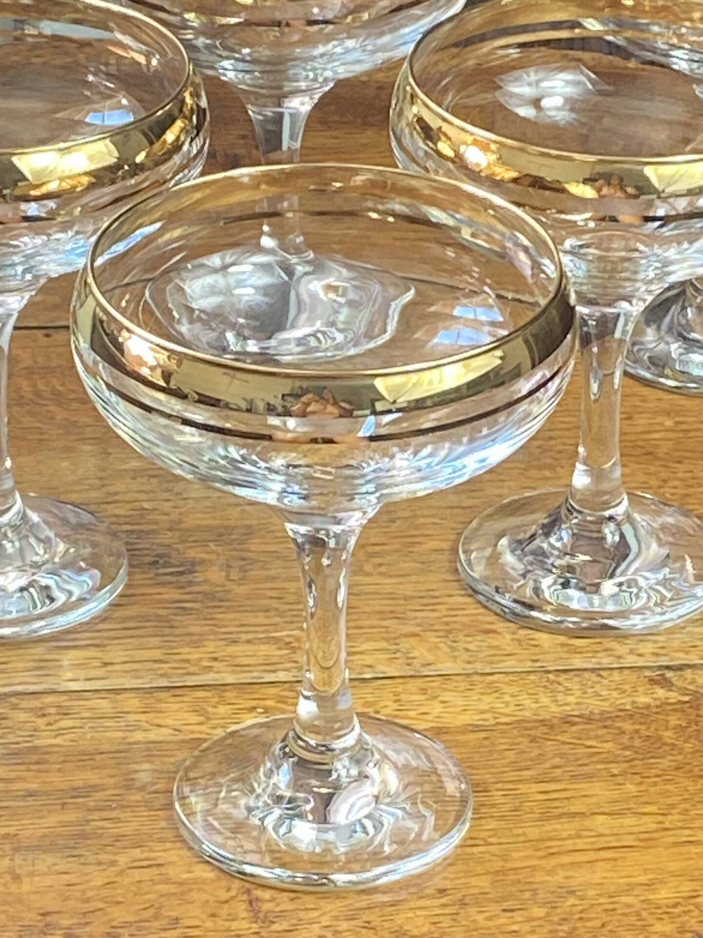 Champagne coupes or cocktail glasses with gilding
