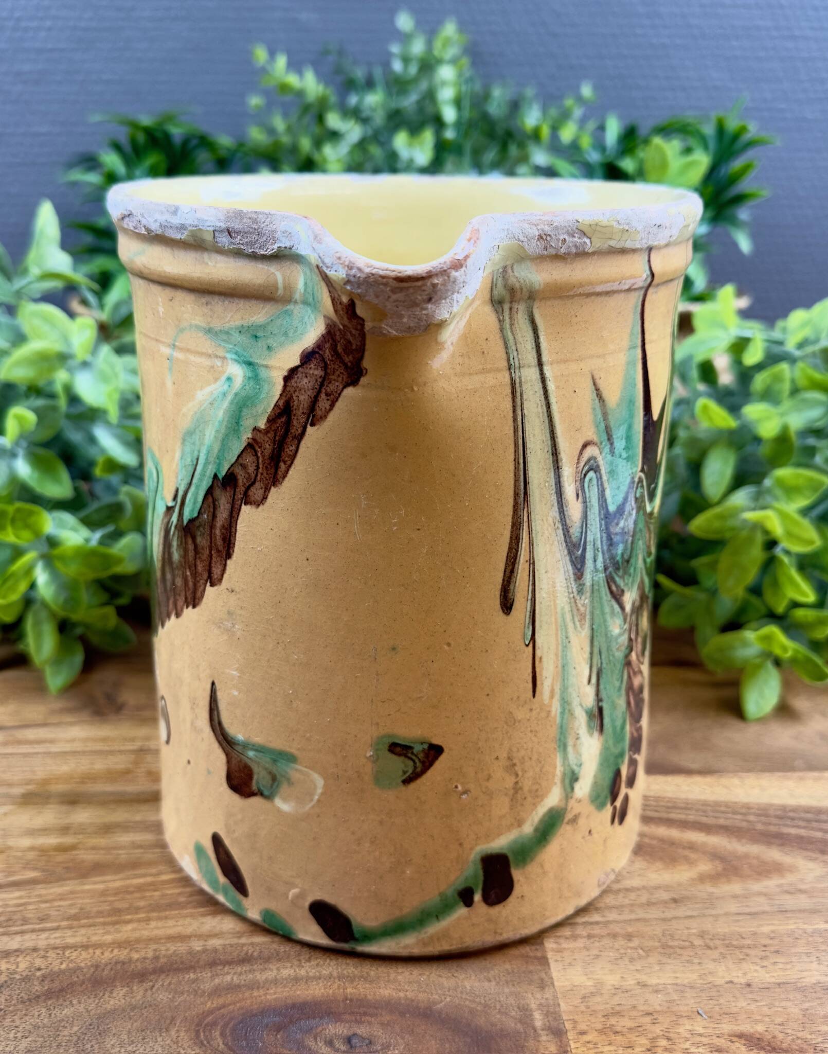 Large vintage ceramic pitcher with abstract green and brown decoration.