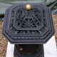 Black cast iron wood burning stove with solid brass handle.