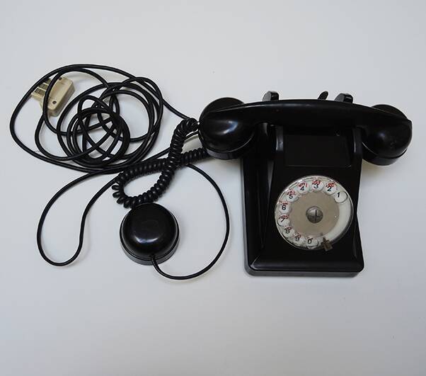 Old ptt phone with rotary dial in black bakelite