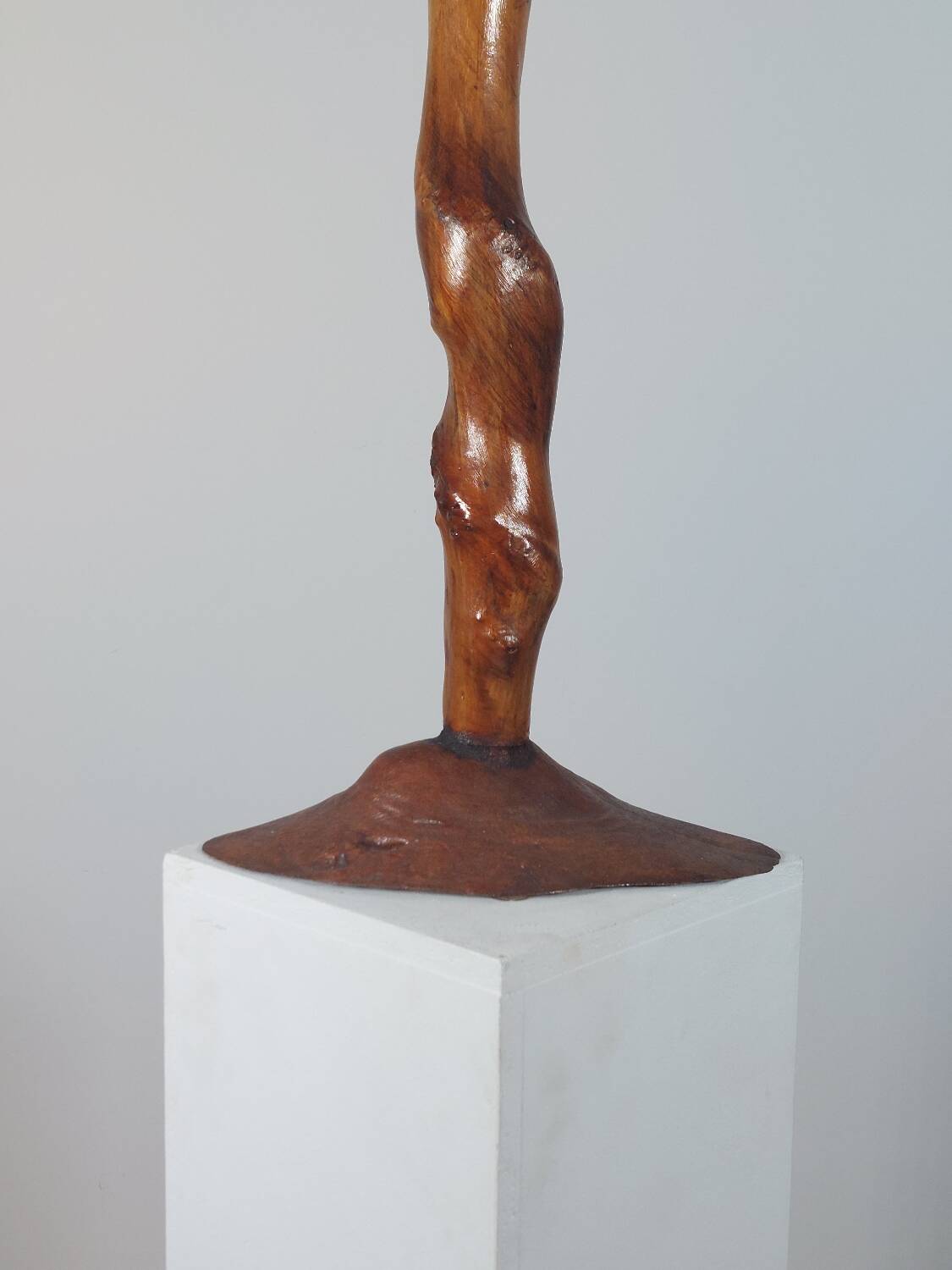 Vintage candle holder in an organic shape with a brass spike and tiered top.