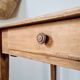 Small old farmhouse table in raw wood.