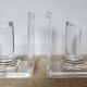Pair of column bookends in plexiglass and gold metal, 1980s design.