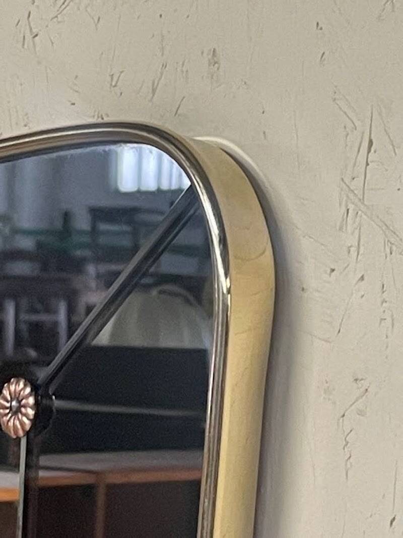 1950s double-thickness wall mirror with brass profile and supports.