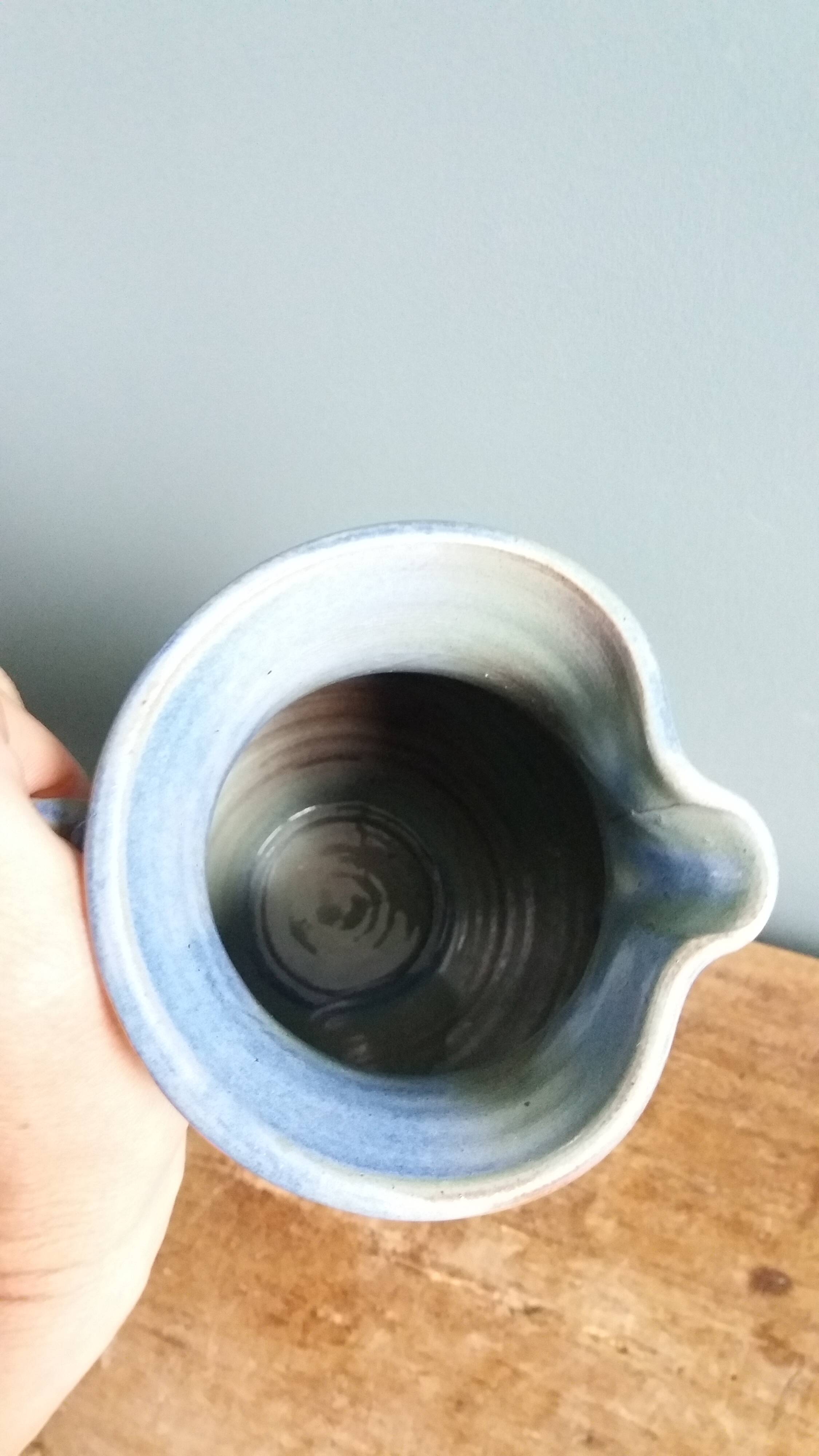 Enamel pitcher in pastel blue and green, signed