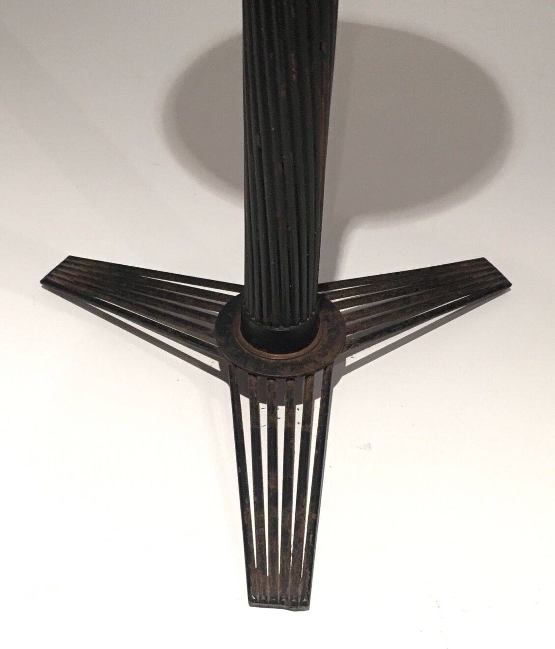 Brass ashtray on a stand made of black lacquered metal wire.