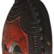 African wooden mask, face topped with a bird.