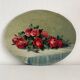 Old oil painting on oval wood with roses thrown from the 30s
