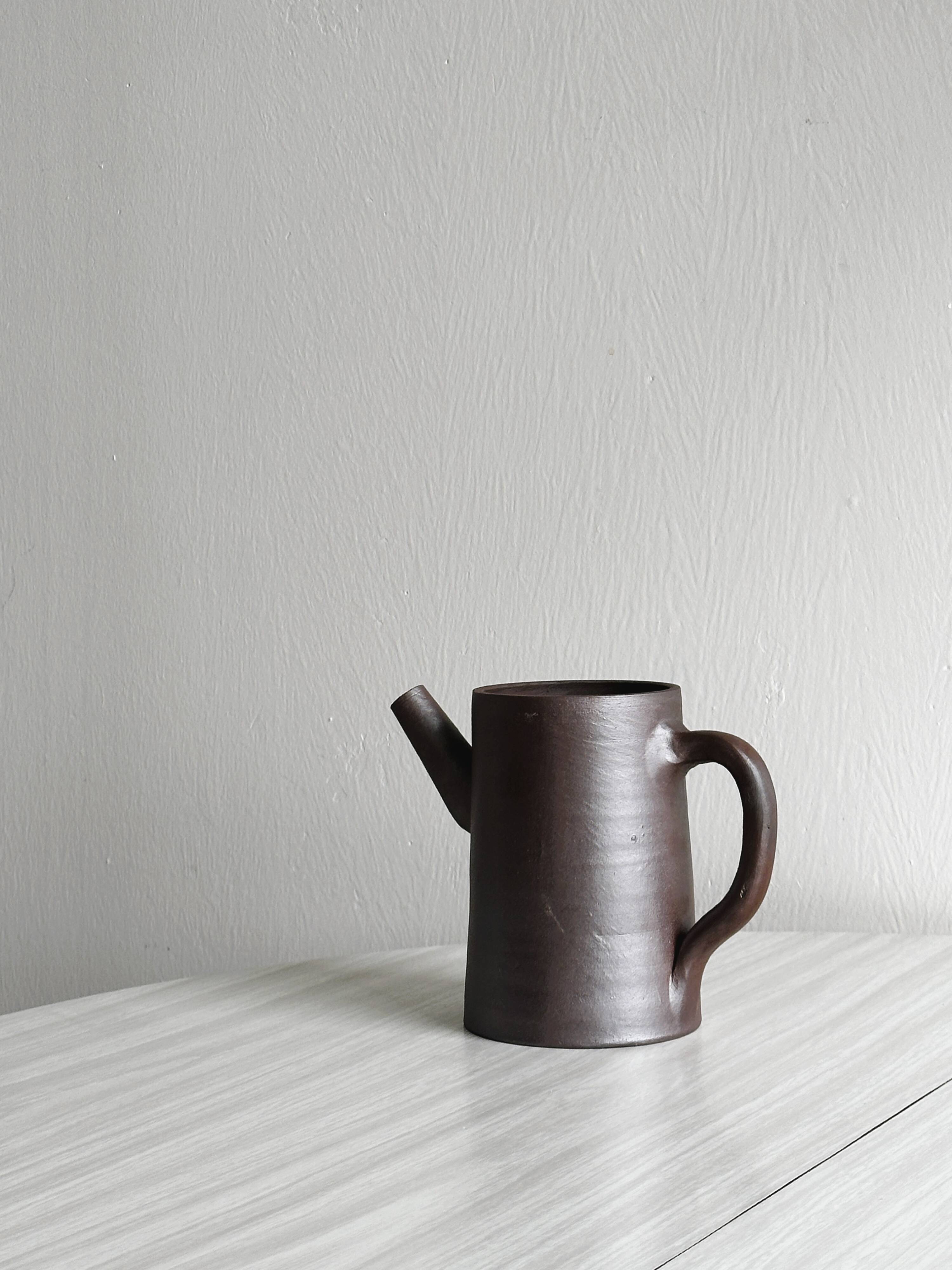 Small pitcher in brown glazed stoneware