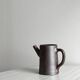 Small pitcher in brown glazed stoneware