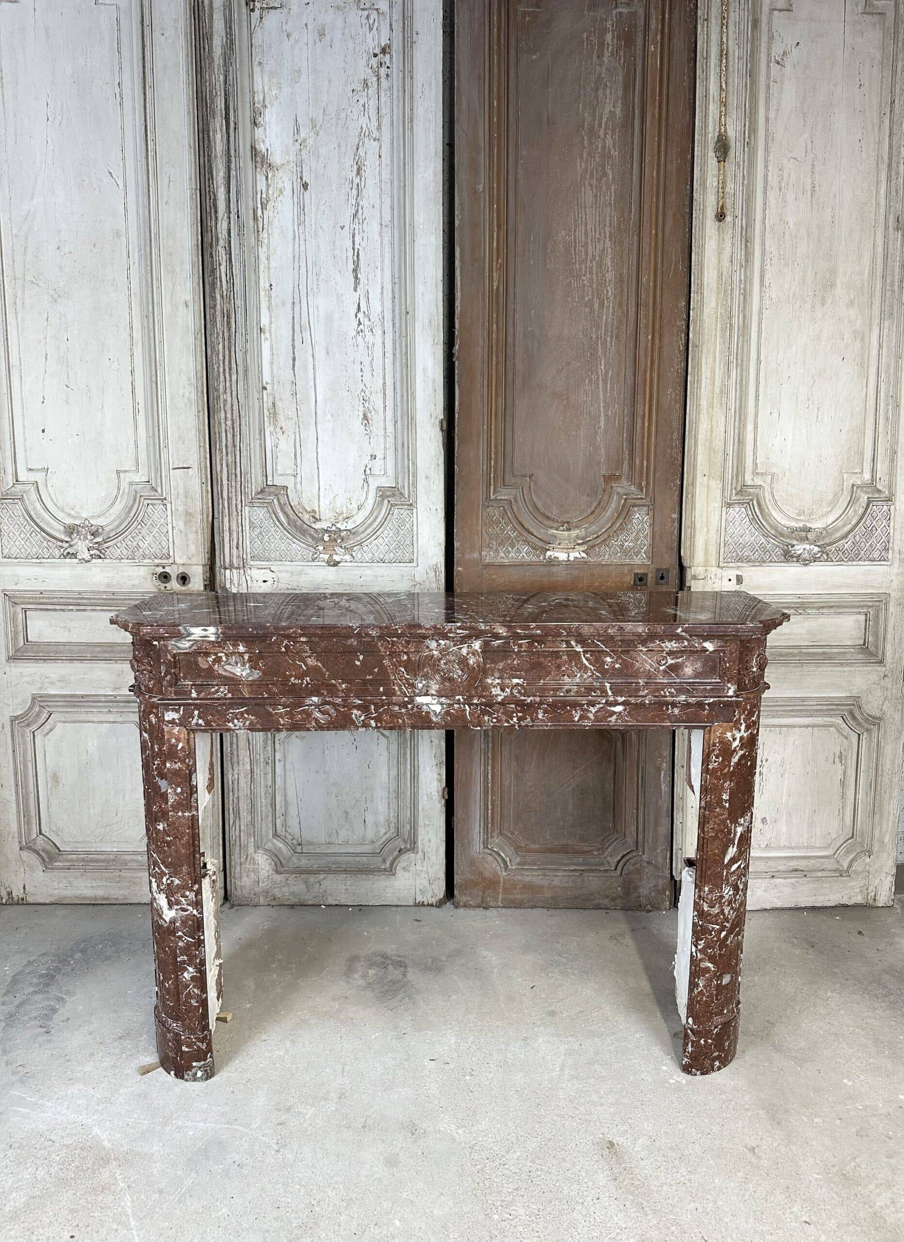 Red marble fireplace in the Louis XVI style, late 19th century