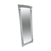 Miroir patiné beige avec des têtes de femme