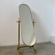 Old free-standing mirror in gilded brass in psychedelic neoclassical style Years 40 France