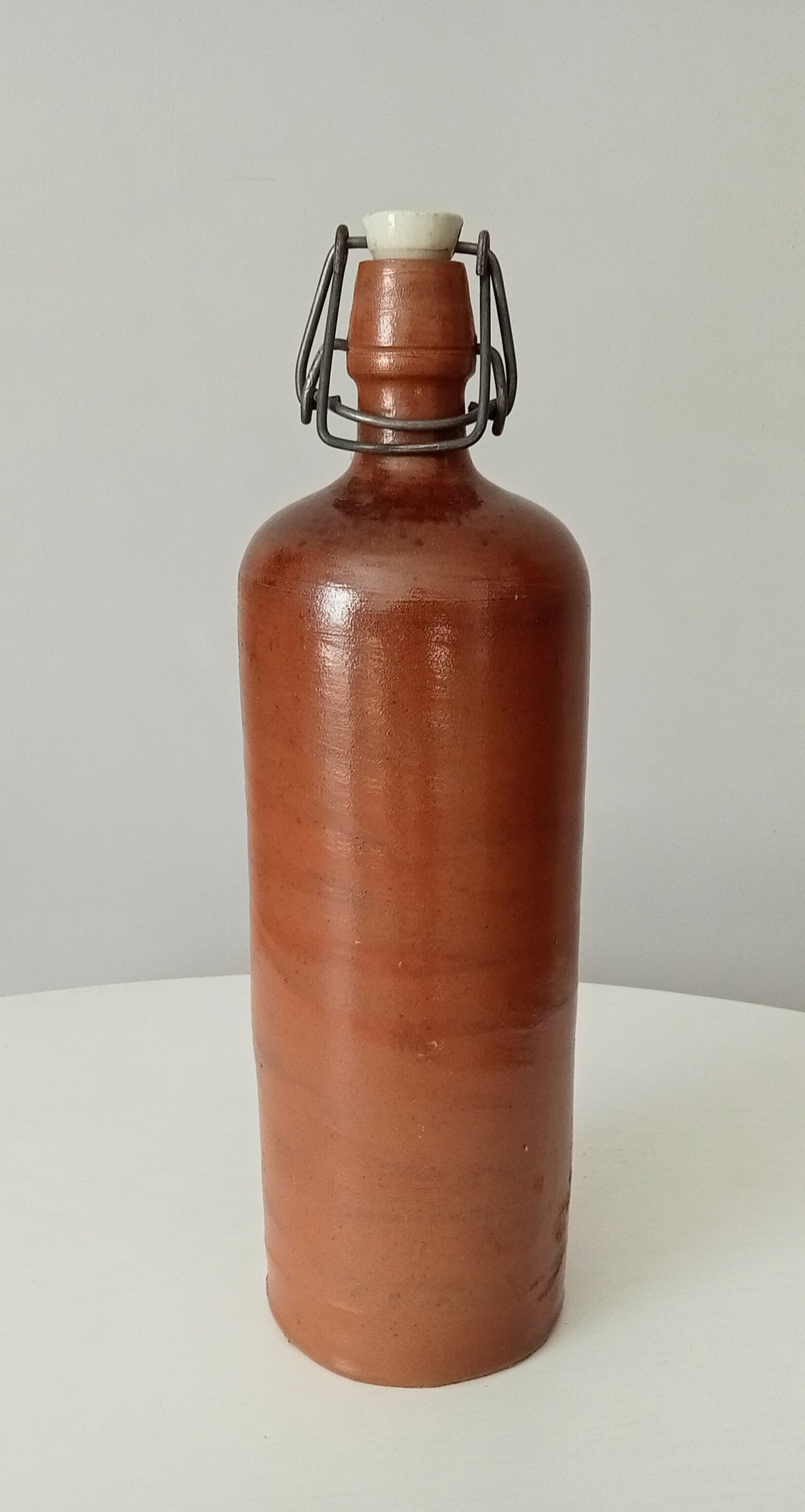 Old bottle in glazed sandstone