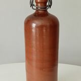 Old bottle in glazed sandstone