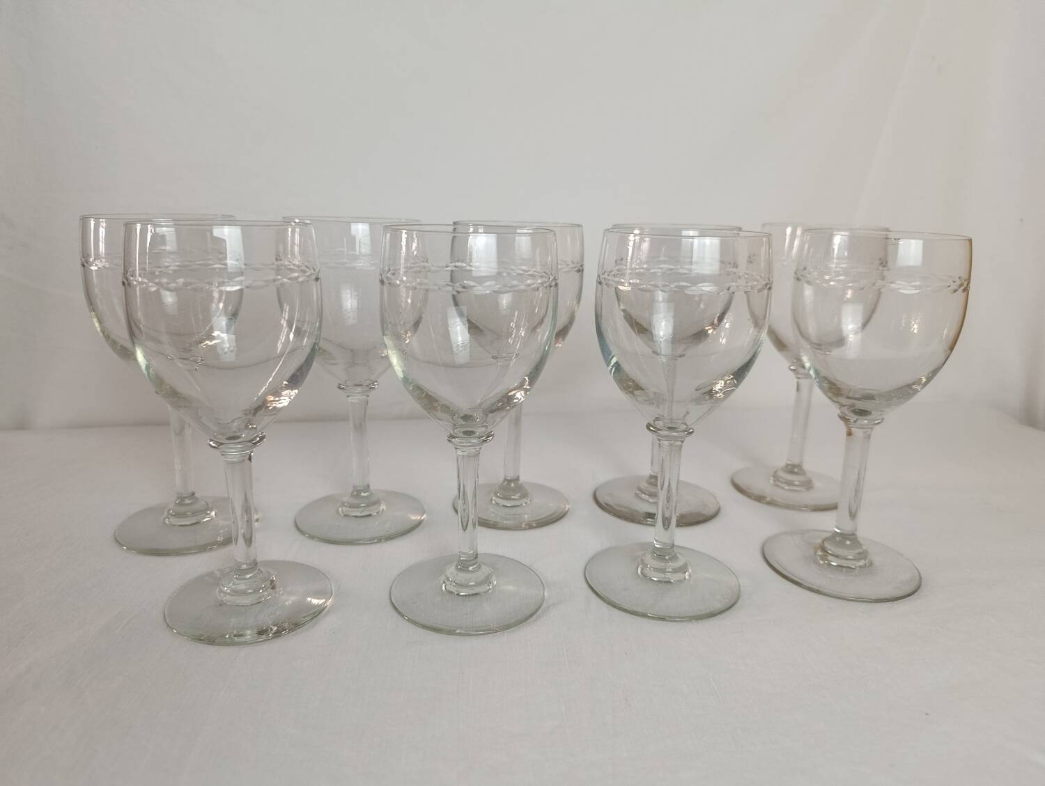Set of 11 antique engraved crystal liqueur glasses.
