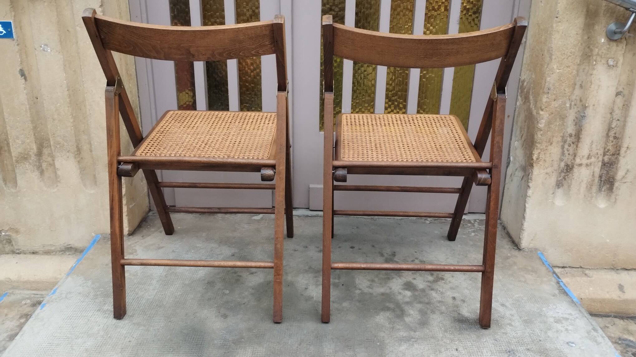 Pair of vintage wooden and cane folding chairs