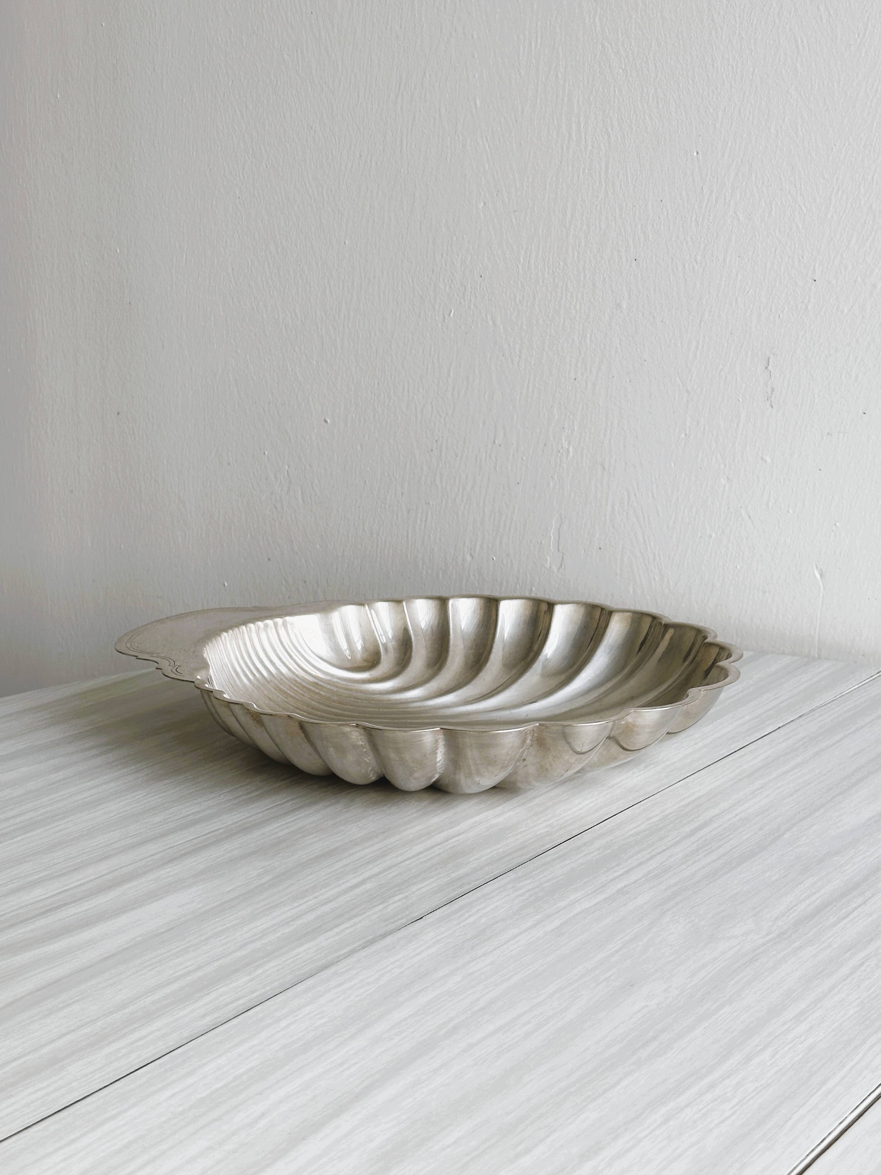 large silver-plated metal shell-shaped dish
