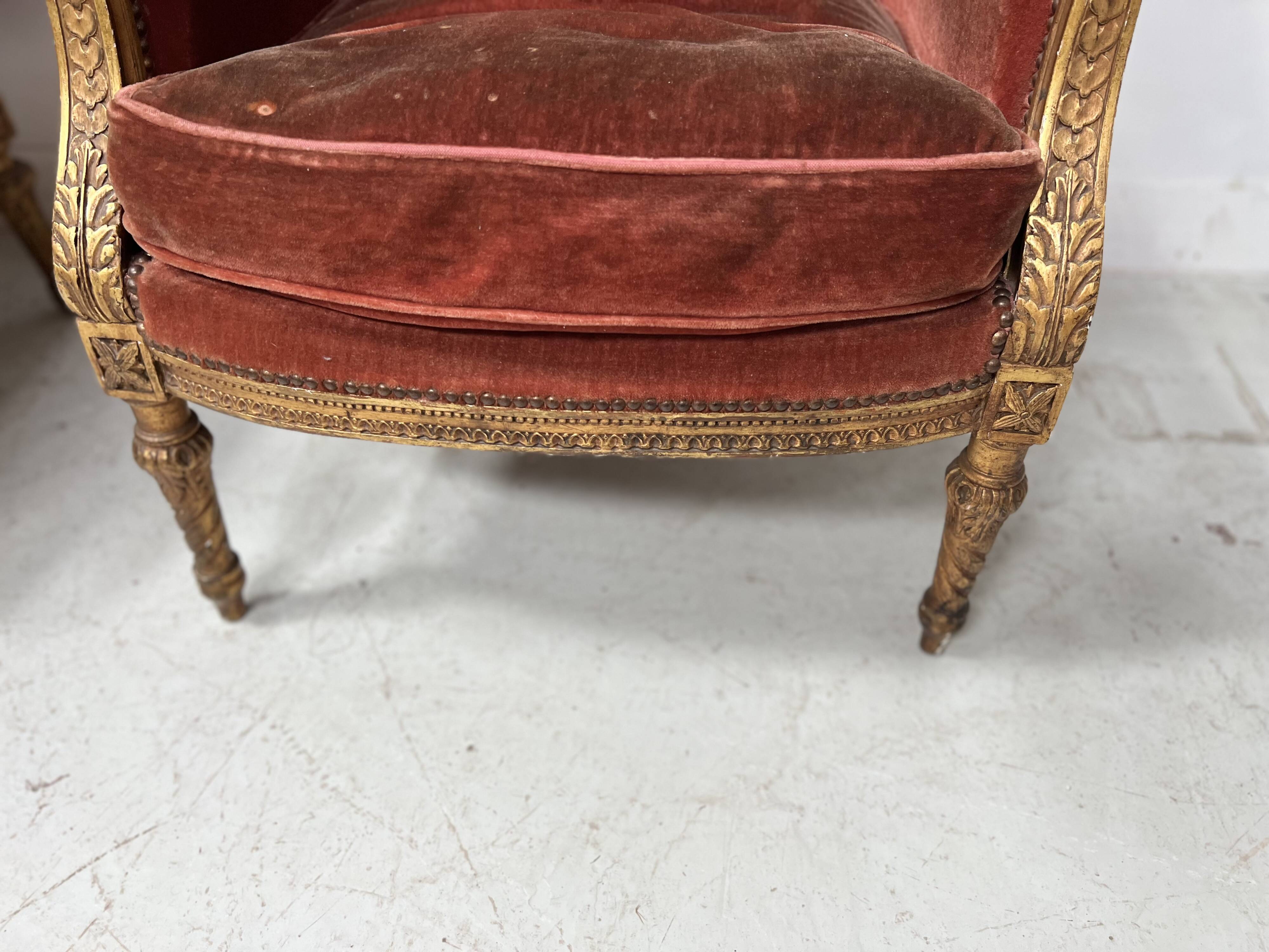 Two Louis XVI style wing chairs in gilded wood, 20th century
