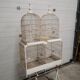 Double cage with birds in wooden metal white rectangular bell tower 1910