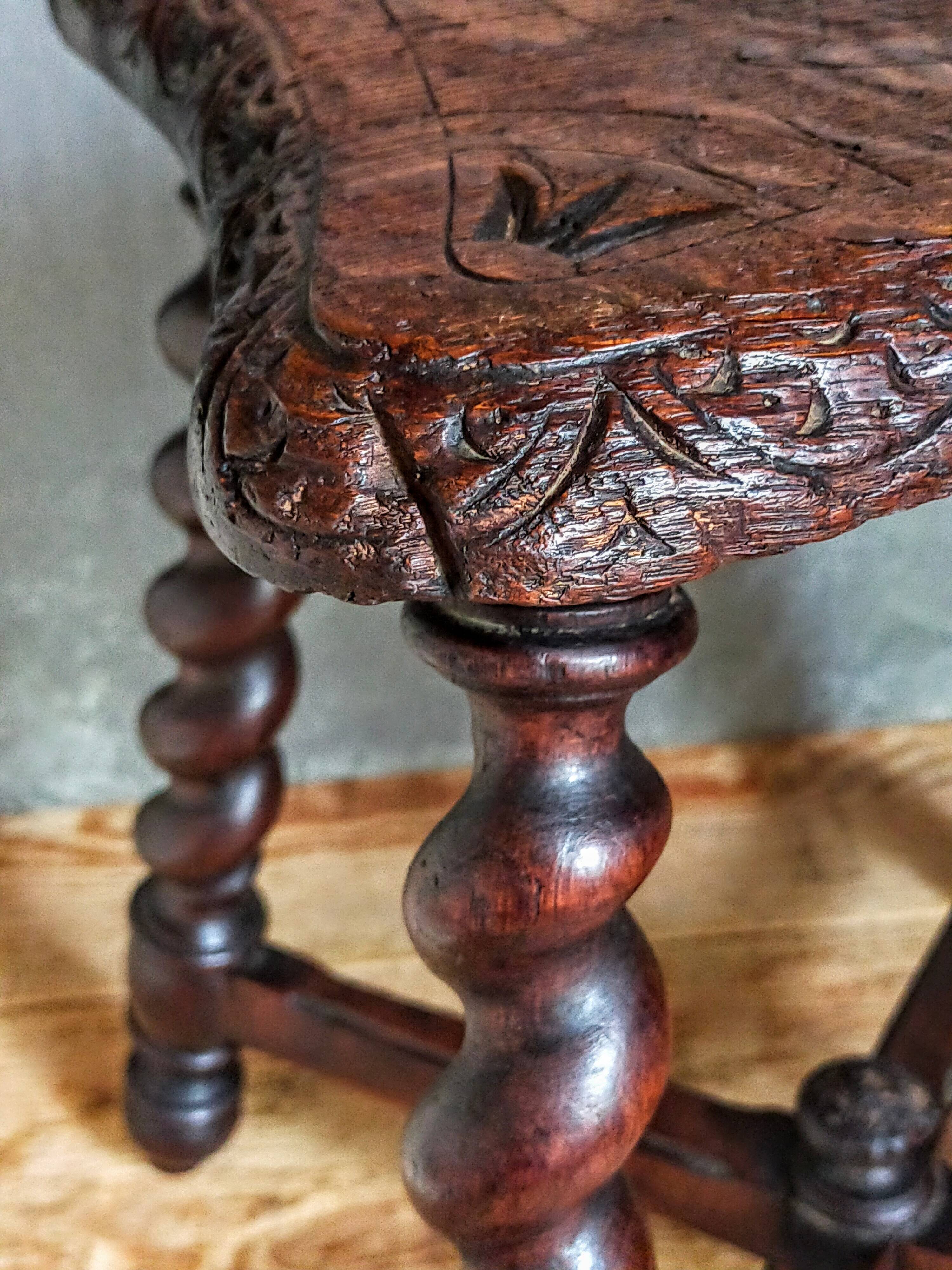 Antique stool in turned and carved solid wood