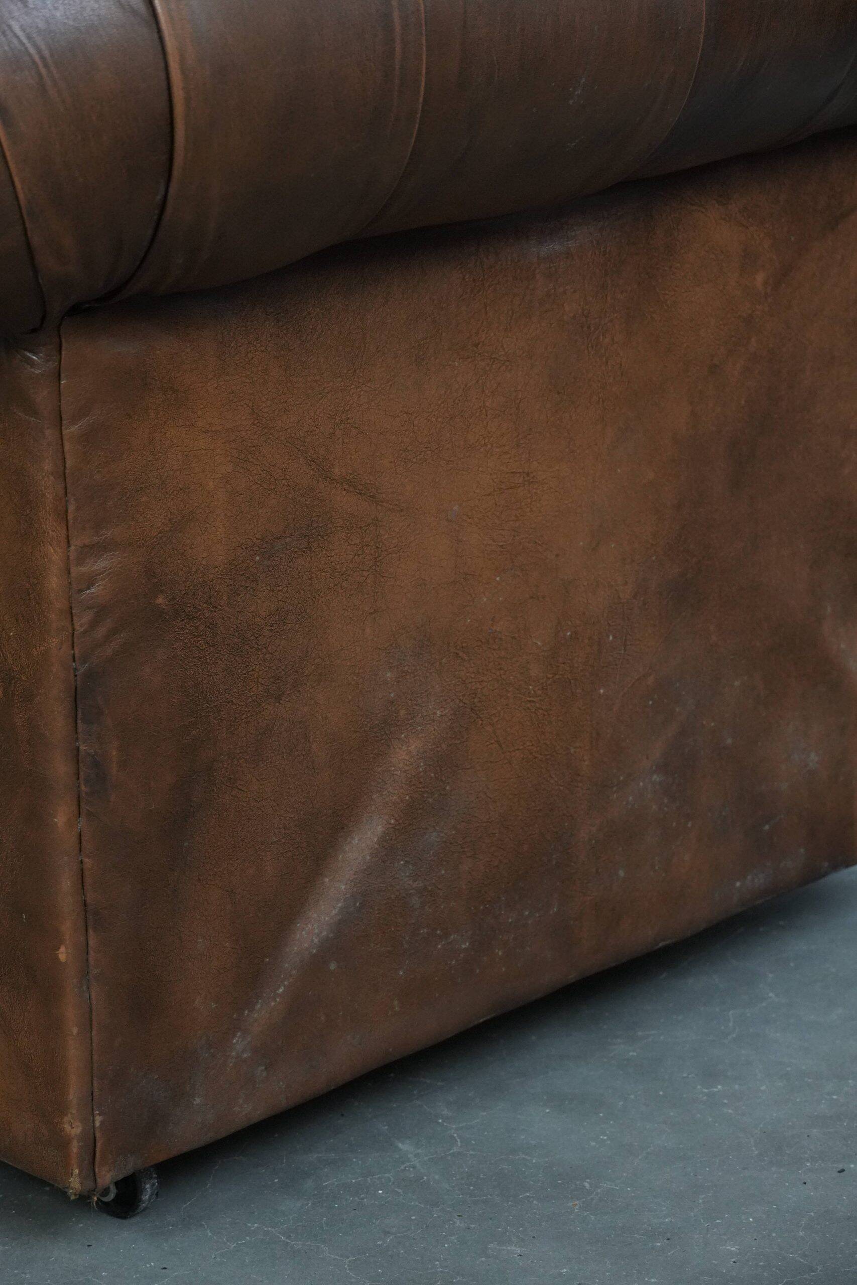 Brown cowhide leather chesterfield armchair  in English style on wheels