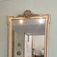 large antique mirror with richly carved pediment in Louis XV / Napoleon style