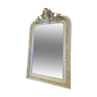 Patinated beige and gold mirror with an angel