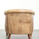 Vintage cowhide club armchair in English style in a light colour scheme