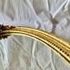 Antique oval wall mirror in gold resin - 63 cm
