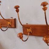 Pair of double coat hooks from the end of the 19th century, circa 1900, in wood and varnished metal
