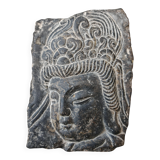 Antique portrait of Buddha hand-carved in stone, 19th century.