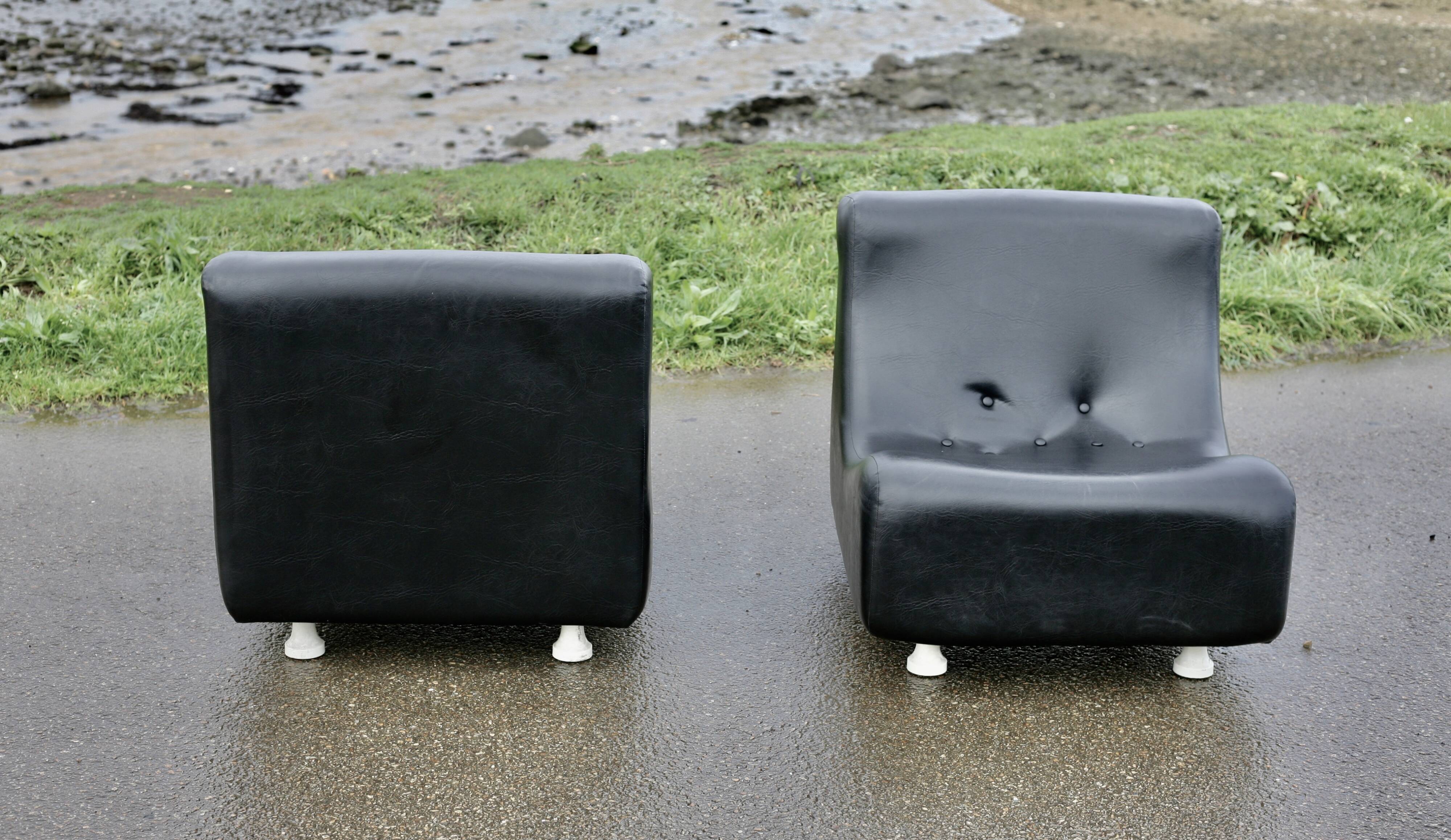 Pair of “space age” low chairs. Black faux leather. Circa 1970