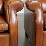 Set of 2 very comfortable large sheepskin armchairs elegantly finished with black piping