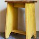 Art-populaire workshop stool in patinated painted wood