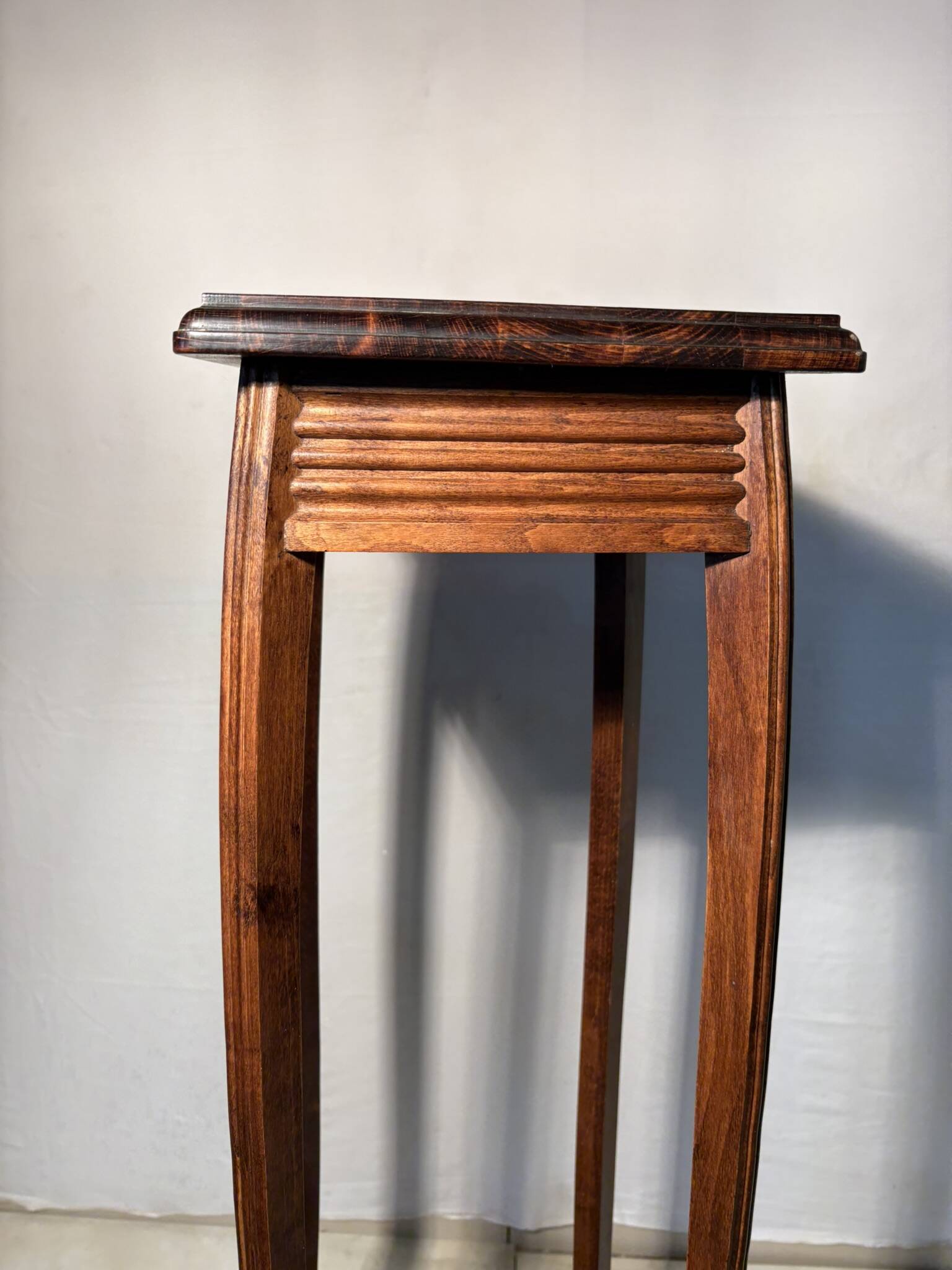 Vintage dark wood side table with curved base