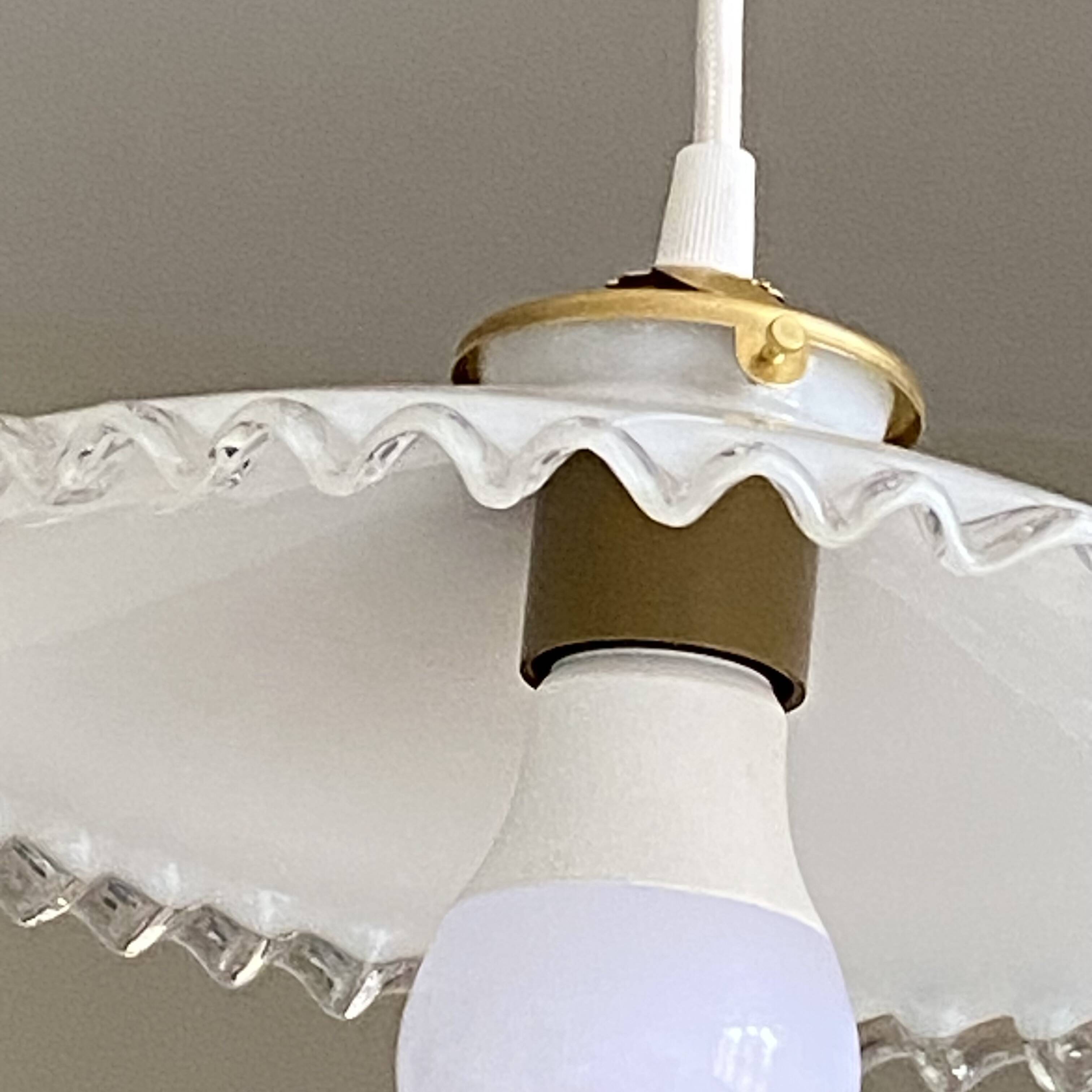 Old lampshade in white opaline glass with a wavy edge.