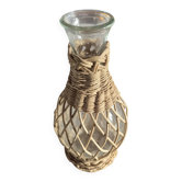 vintage glass vase surrounded by woven rattan