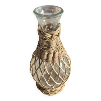 vintage glass vase surrounded by woven rattan