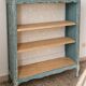 Antique wooden bookshelf with a patinated blue-green finish.