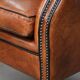 Wingback chair made of sheep leather with black piping in good condition