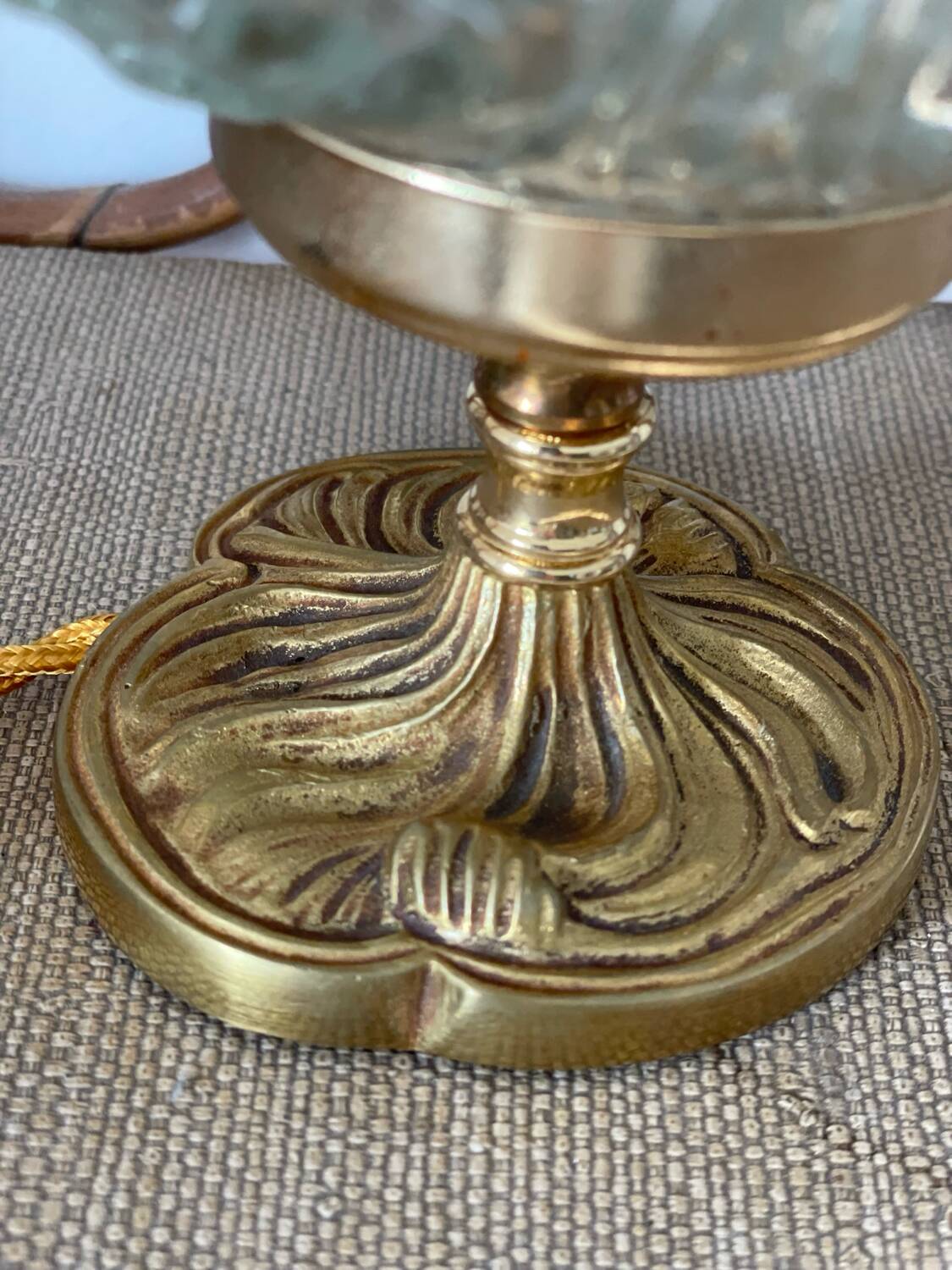 Textured round globe table lamp with a gold brass base